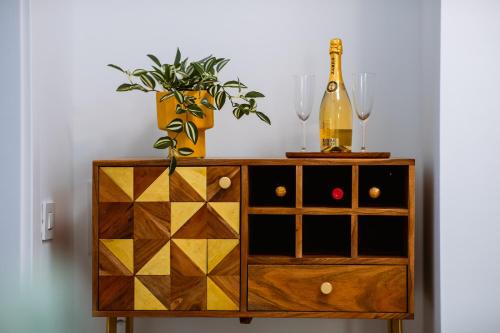 a wooden cabinet with a bottle of wine and a plant at Mountain View with Terrace in Sinaia
