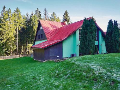 a house with a red roof on a green field at Holiday Home Jelení kout by Interhome in Smržovka