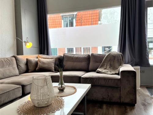 a living room with a couch and a table at Holiday Home Brouwershaven by Interhome in Brouwershaven