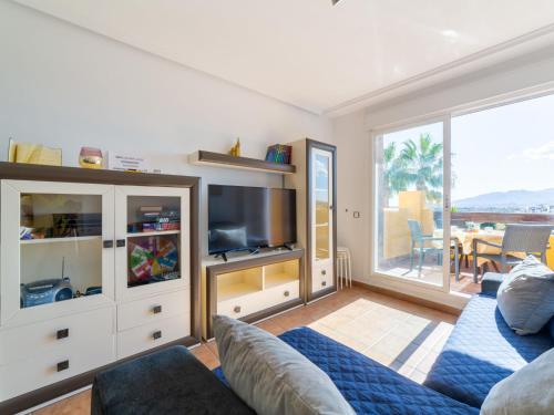 a living room with a couch and a tv at Apartment Lomas del Mar V-2 by Interhome in Playas de Vera