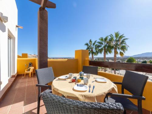 a table and chairs on a balcony with a view at Apartment Lomas del Mar V-2 by Interhome in Playas de Vera