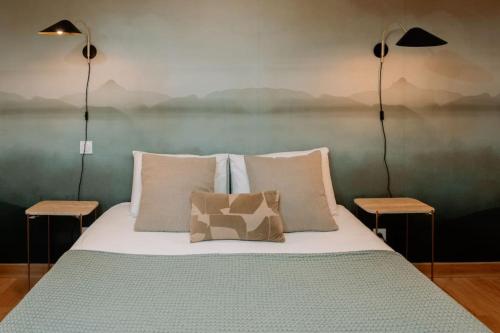 a bedroom with a bed with two lamps on it at Superbe T2 neuf Bonifacio avec parking gratuit in Bonifacio
