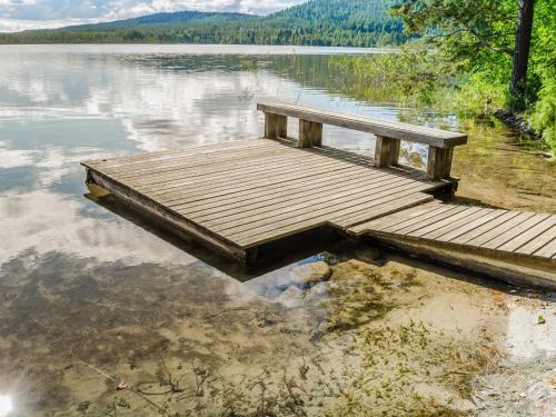 a wooden dock in the water on a lake at Holiday Home Villa adalmina by Interhome in Hattusaari