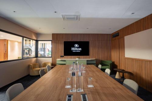 a conference room with a large wooden table with chairs at Hilton Paris La Défense in Puteaux