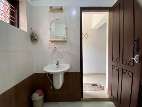 a bathroom with a sink and a mirror at Mango Villa in Varkala
