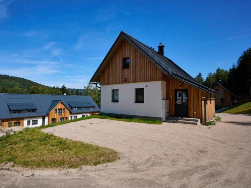 a barn with a white and brown at Holiday Home Muhu by Interhome in Smržovka