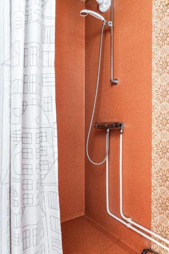 a shower in a bathroom with a shower curtain at Chalet Norrskensstugan by Interhome in Vidsel