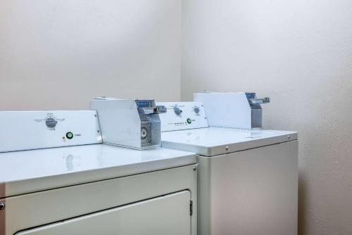 two white appliances sitting on top of a washing machine at Travelodge by Wyndham Livingston in Livingston