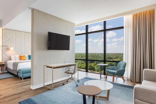 a hotel room with a bed and a large window at Avani Cancun Airport -previously NH Cancun Airport- in Cancún