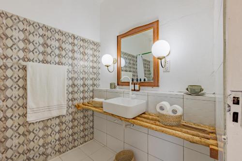 a bathroom with a sink and a mirror and towels at Fully Furnished 2 Bedroom Apartment along Diani Beach Road in Diani Beach