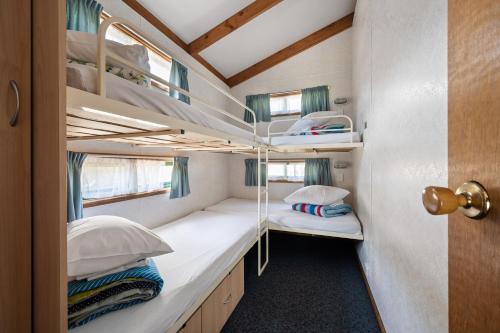 a small bedroom with bunk beds in a tiny house at Bright Accommodation Park in Bright