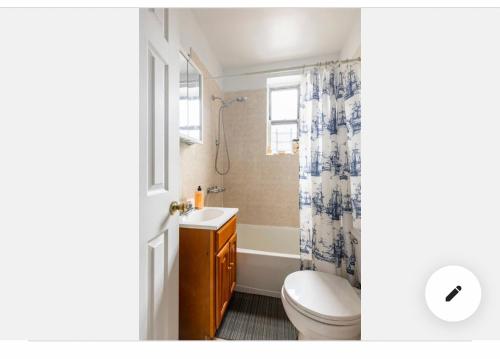 a bathroom with a toilet and a sink and a shower at Deluxe Manhattan room in New York