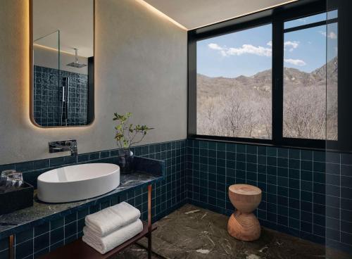 a bathroom with a sink and a large window at Commune by the Great Wall, in the Unbound Collection by Hyatt in Yanqing