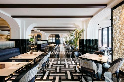 a restaurant with tables and chairs in a room at Hilton Yokohama in Yokohama