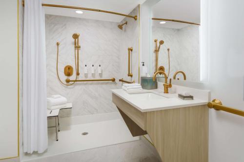 a bathroom with a sink and a shower at Beal House Fort Walton Beach, Tapestry Collection By Hilton in Fort Walton Beach