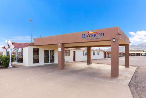 a building with a bankowment sign in a parking lot at Baymont by Wyndham Socorro in Socorro