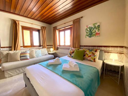 a bedroom with two beds with towels on them at Monte Gordo Beach 1 by Homing in Monte Gordo