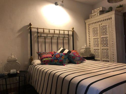 a bedroom with a large bed with pillows on it at Los Diezmos in Torremocha de Jarama