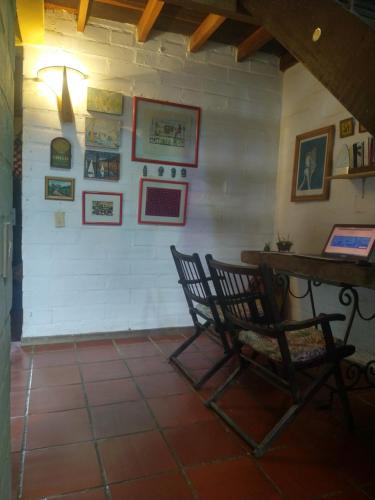 a room with a table and chairs and pictures on the wall at Casa Vitall in Líbano