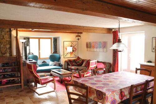 a living room with a table and chairs at Panorama Gîtes Certes in Gaudiès