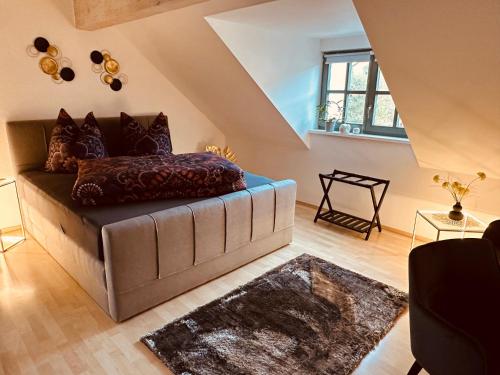 a living room with a couch and a window at Apartment Altstadt Freiberg in Freiberg