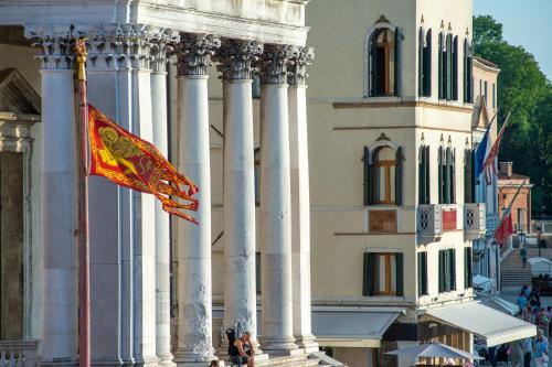 a flag is flying in front of a building at Hotel Antiche Figure in Venice