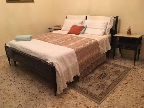 a bedroom with a large bed with two pillows at RENT ROOM JOE Via Dante 77 Solarino in Solarino