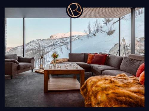 a living room with a couch and a table at The Hills in Grøndalen