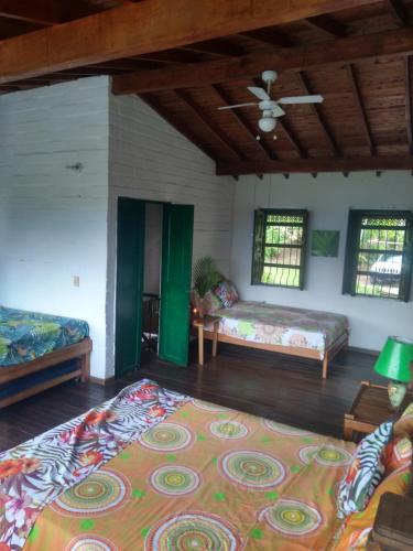 a living room with two beds and a rug at Casa Vitall in Líbano
