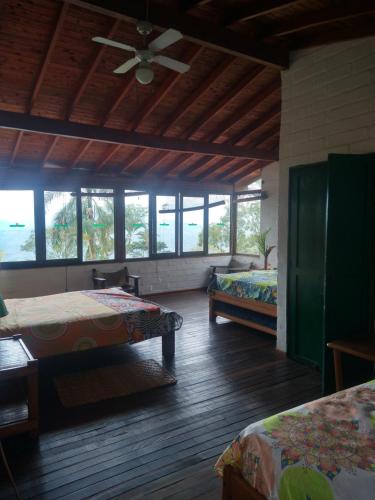 a room with two beds and a ceiling fan at Casa Vitall in Líbano
