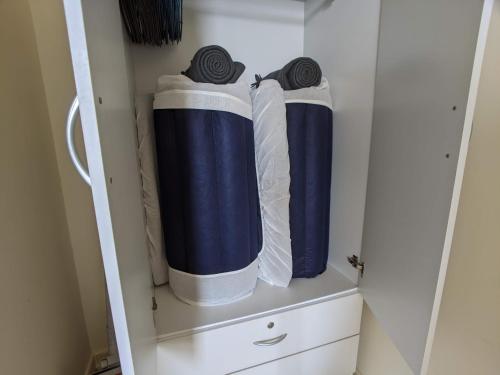 a closet with blue and white towels on a shelf at Tamarind Suites or D'Pulze Residence or Domain NeoCyber, click Room selection for location and pics in Cyberjaya