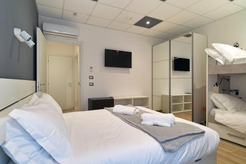 a bedroom with a white bed with two pillows on it at B&Bike Como Lake in Castelmarte