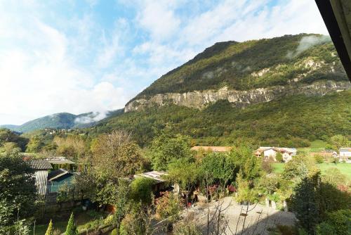 a view of a mountain with houses and trees at B&Bike Como Lake in Castelmarte