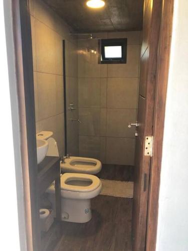 a bathroom with two toilets and a sink at Casa sobre el río in Posadas