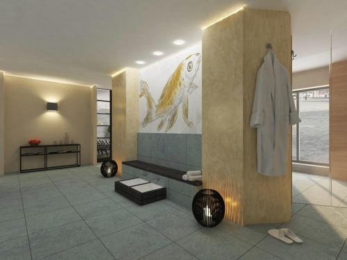 a bathroom with a robe and a painting on the wall at Ohlerich Speicher App 48 in Wismar