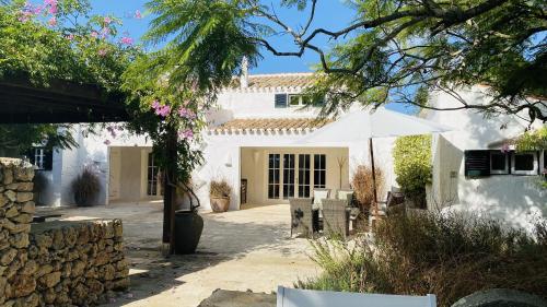聖克萊蒙的住宿－Holiday Home Casa MADORIA，白色的房子,配有桌子和雨伞