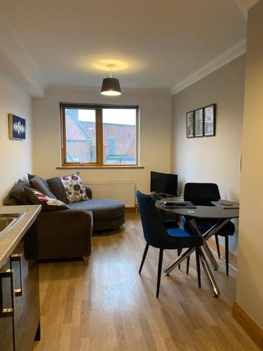 a living room with a couch and a table at 1 bedroom apartment in Norwich city centre in Norwich