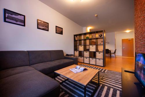 a living room with a couch and a coffee table at Hotel Spolcentrum in Svit