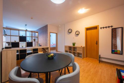 a living room with a table and chairs at Hotel Spolcentrum in Svit