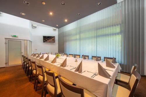 a large conference room with a long table and chairs at Hotel Spolcentrum in Svit