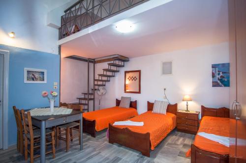 a bedroom with two beds and a loft bed with a table at Apartments Xara in Velika