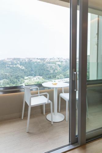 a room with a table and chairs and a window at Rodos Palace Hotel in Ixia