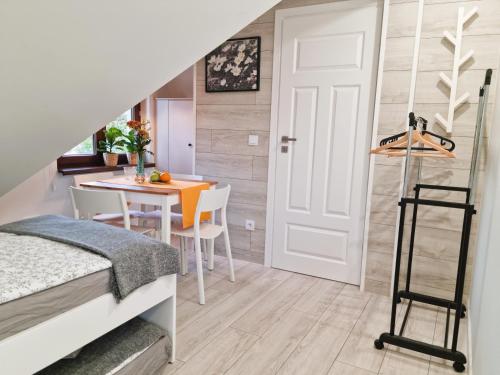 a bedroom with a bed and a dining room with a table at Gościniec Skorusa in Kościelisko