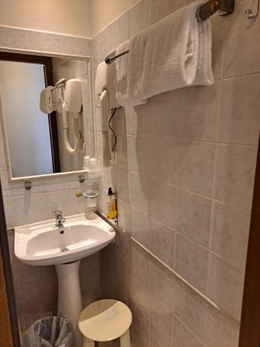 a bathroom with a sink and a toilet and a mirror at Hotel dei Quiriti in Rome