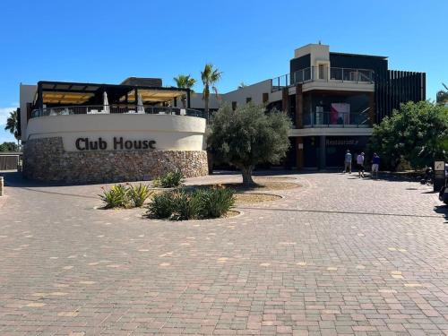 a building with a sign that reads club house at Morderno & Elegante adosado en Roda Golf & Beach Resort in Roda