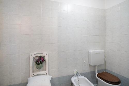 a bathroom with a toilet and a bidet at Sweet Caselle 2 in Testico