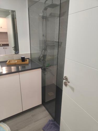 a bathroom with a shower with a glass door at casa Sun&Sand Corralejo in Corralejo