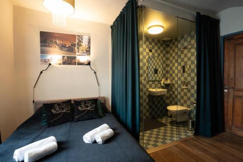 a bedroom with a bed and a bathroom at Two Wheels in Rīga