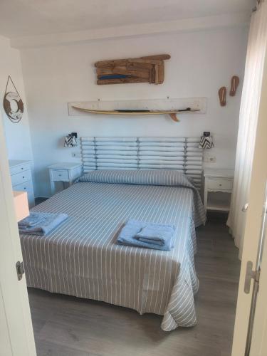 a bedroom with a bed with two towels on it at casa Sun&Sand Corralejo in Corralejo