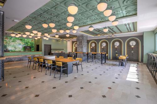 a restaurant with tables and chairs and a ceiling with lights at L'Oceanica Beach Resort in Kemer
